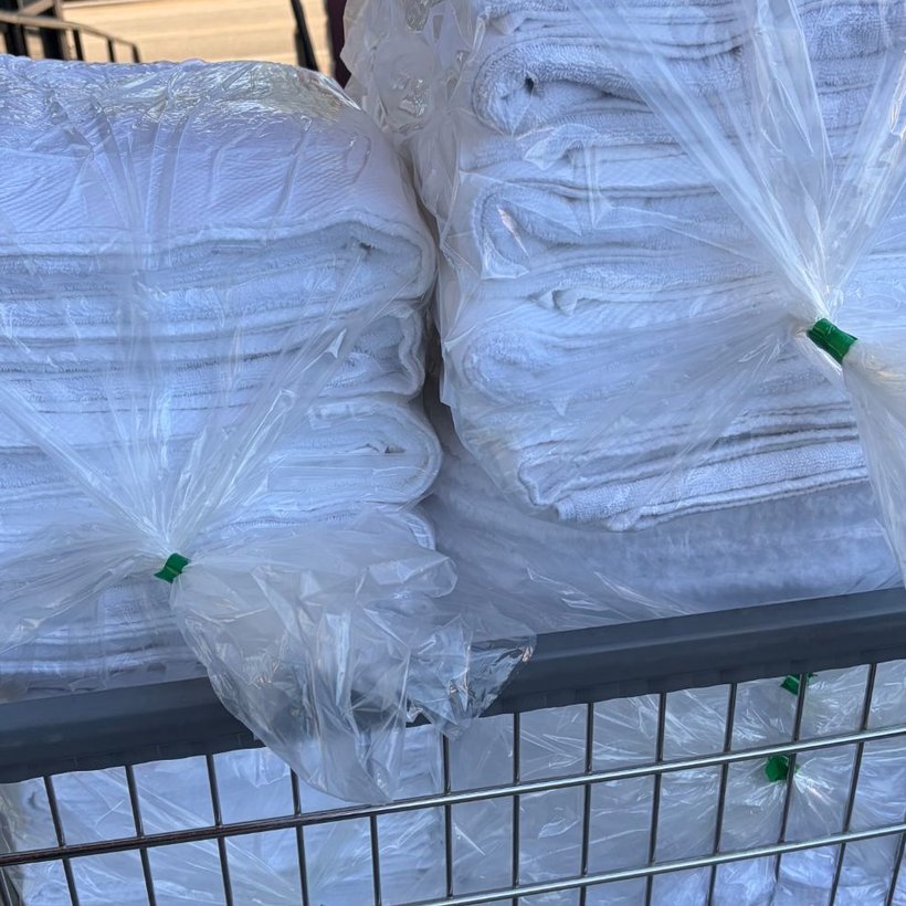 Commercial towels washed, folded and sealed in a laundry cart