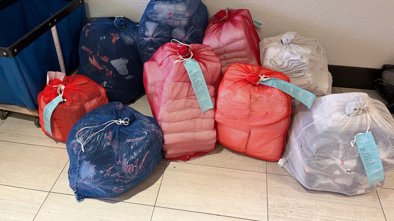 Pepperdine Athletics team laundry in mesh bags, washed, folded and tagged