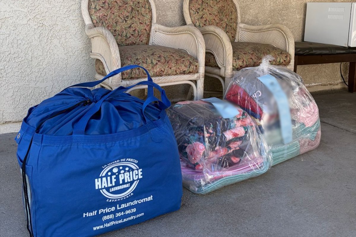 Half Price Laundry pickup and delivery bags dropped off at a customer's door